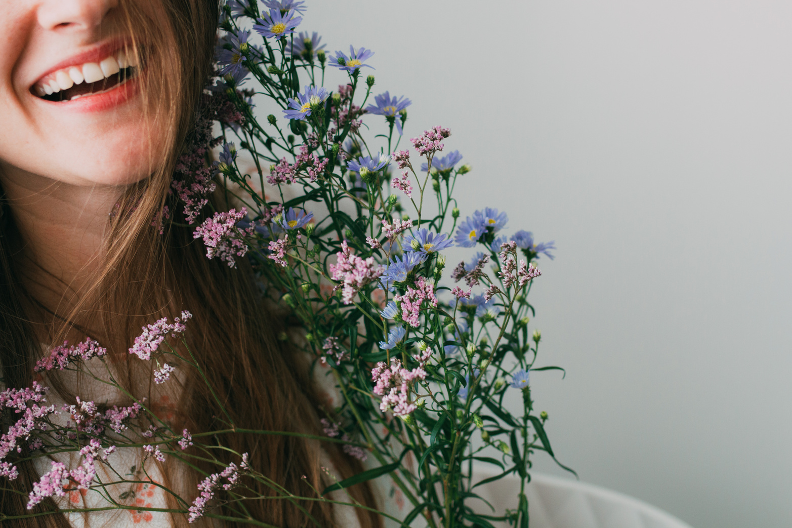 Smiling Woman Holding Flowers